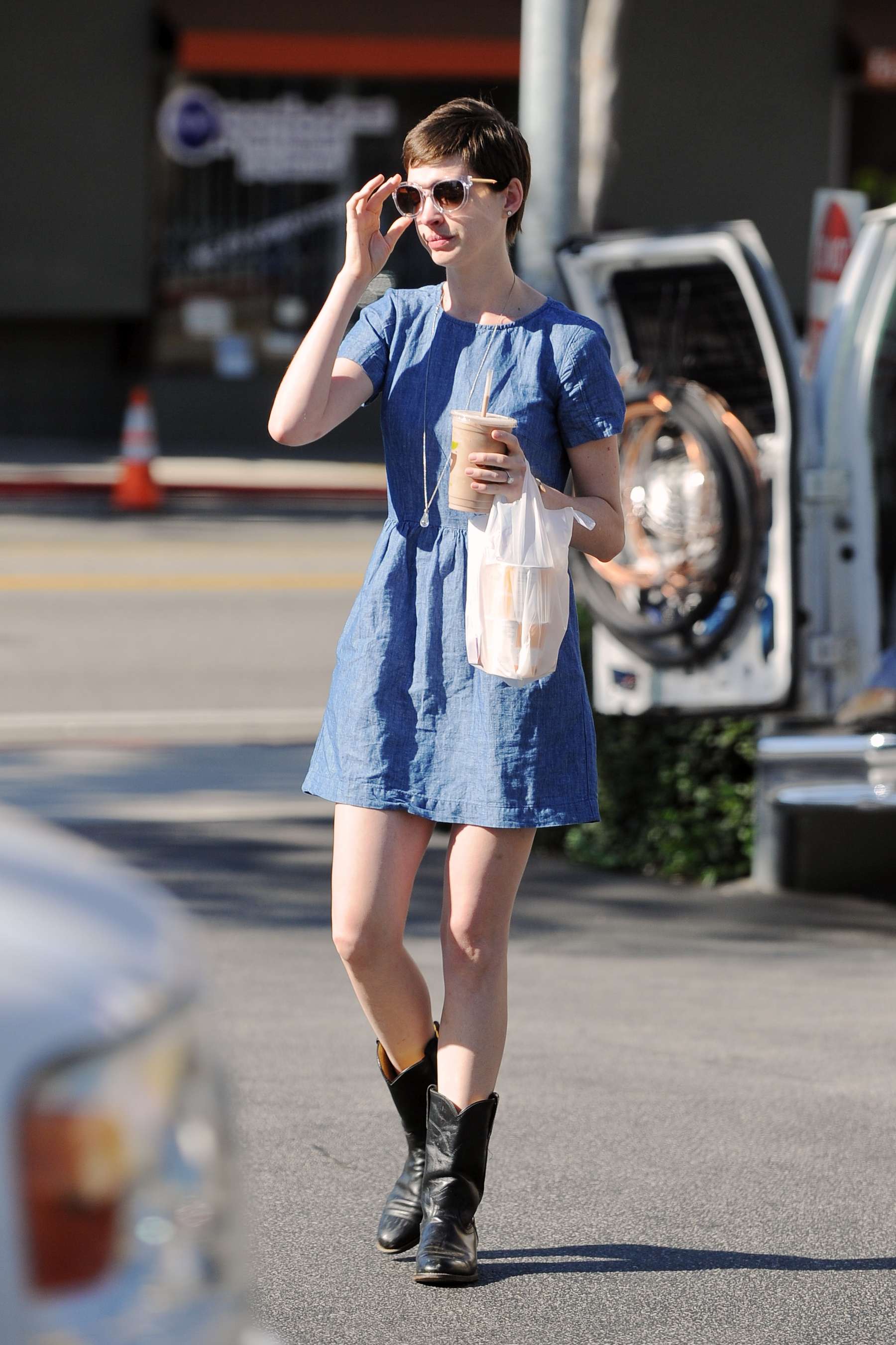 Anne Hathaway in blue mini dress Picking Up Drinks At Earth Bar In West Hollywood